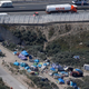 An aerial view shows a field named "new jungle" with tents and makeshift shelters where migrants and asylum seekers stay in Calais, northern France, July 21, 2015.